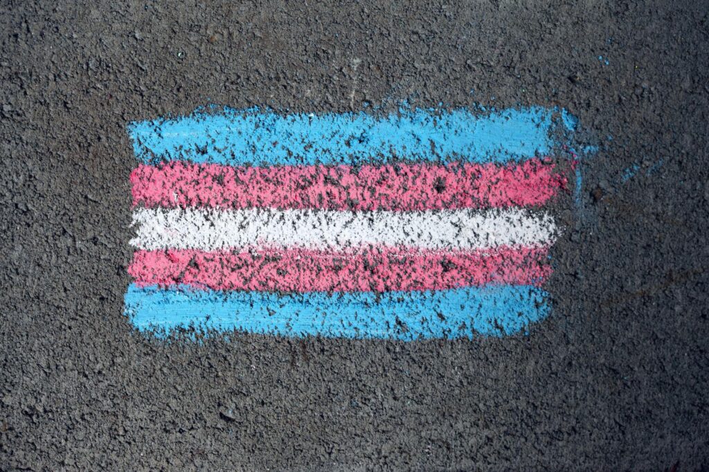 Gros plan d'un drapeau de fierté transgenre dessin à la craie sur une surface rugueuse.