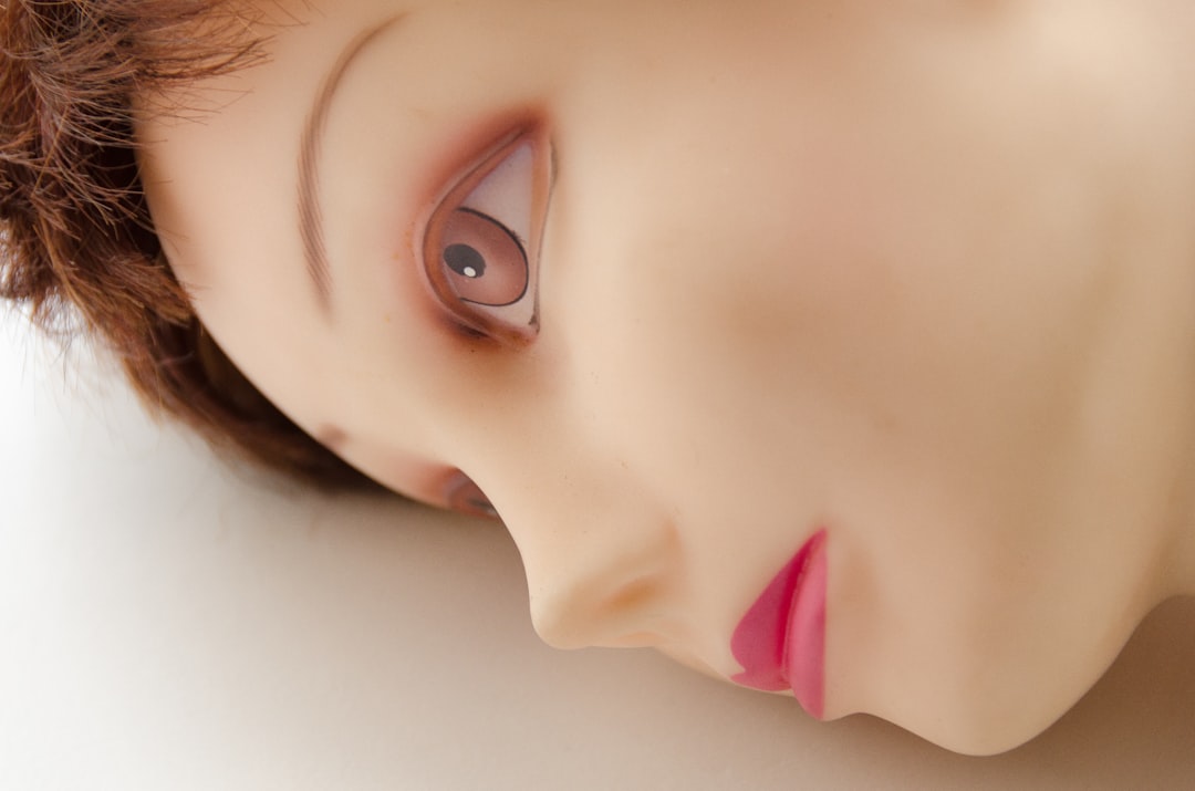un gros plan du visage d'une poupée avec une lèvre rose
